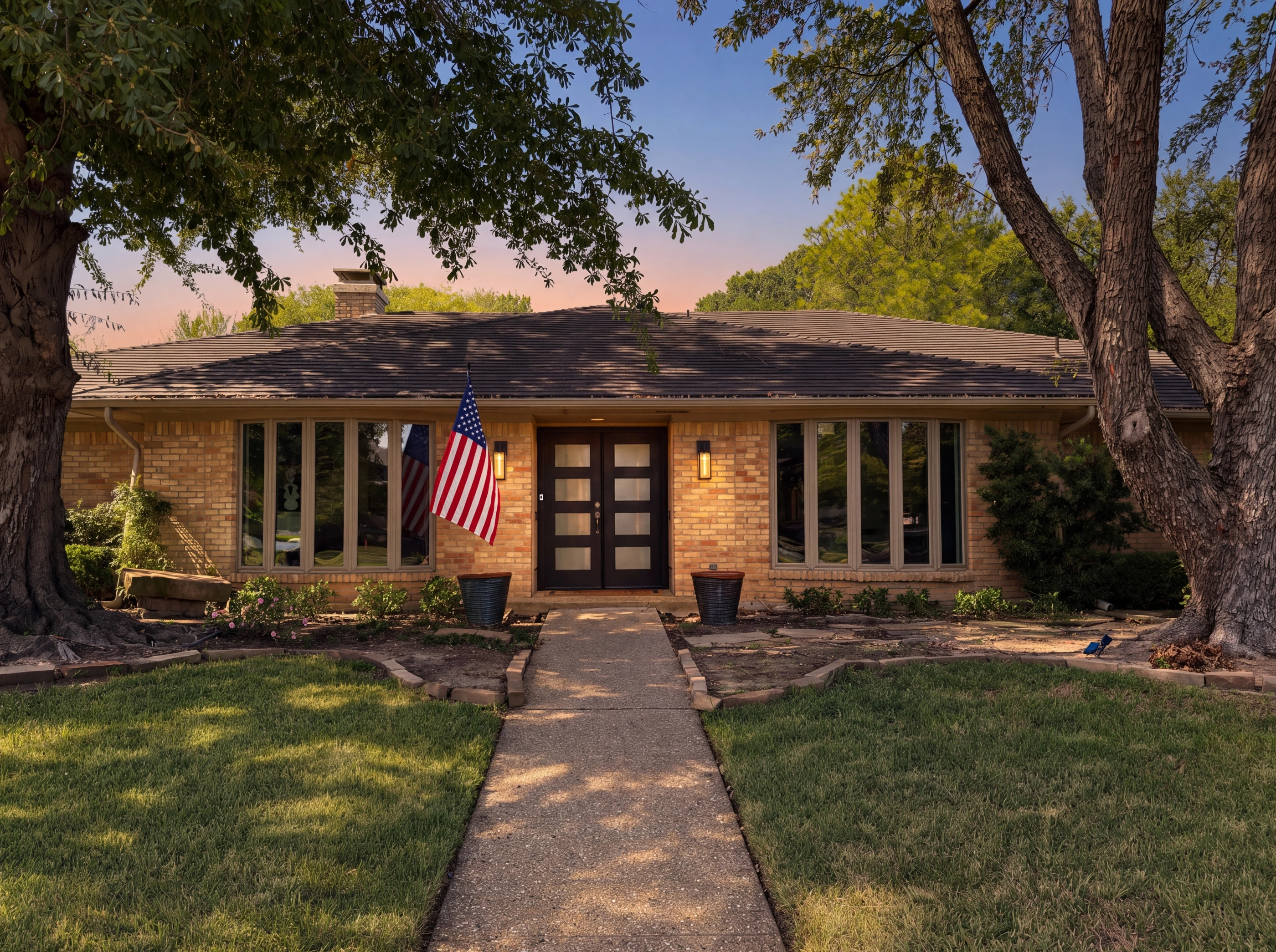 Front elevation with black glass double doors at dusk